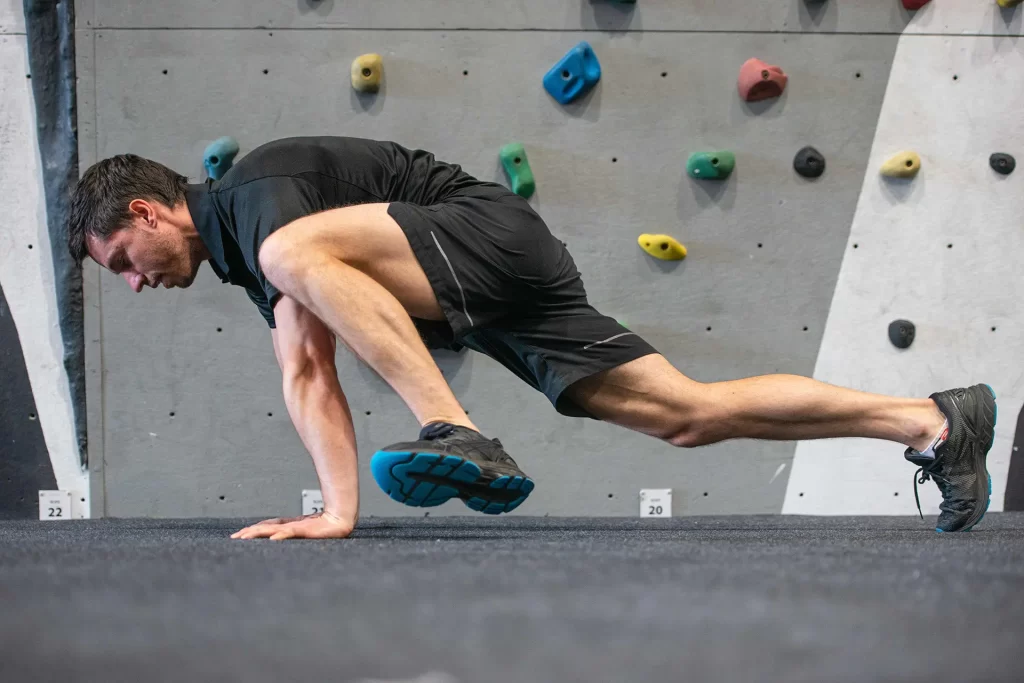 Stretches For Climbing: Best Techniques! 3. highplank with knee to op elbow